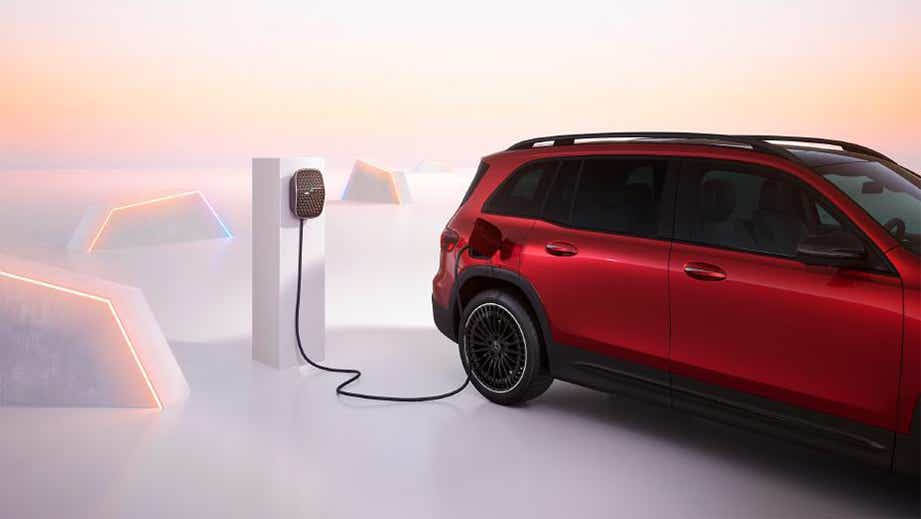 rear three-quarter of a Designo Patagonia Red Mercedes-Benz EQB charging