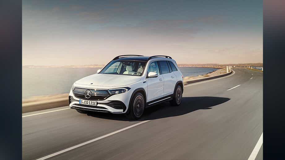 front three-quarter view of a Mercedes-Benz EQB 2022-23 driving on a coastal road