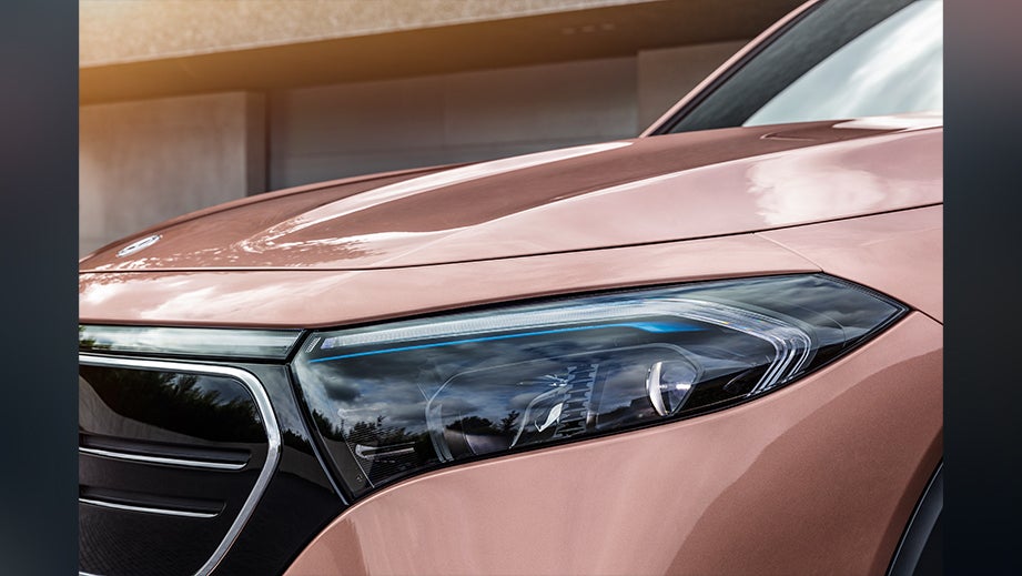 Front headlight close-up of a Rose Gold Metallic Mercedes-Benz EQB 2022-23
