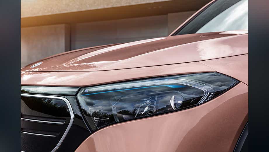 Front headlight close-up of a Rose Gold Metallic Mercedes-Benz EQB 2022-23