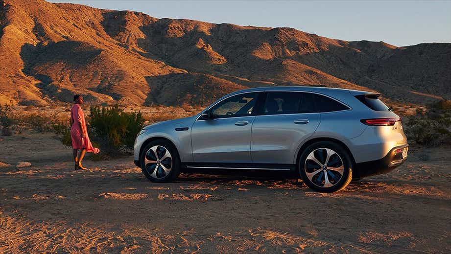 side view of a Polar White Mercedes-Benz EQC in a desert landscape