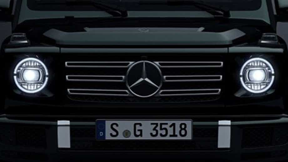 front grille and headlights of a Polar White Non Metallic Mercedes-Benz G-Class