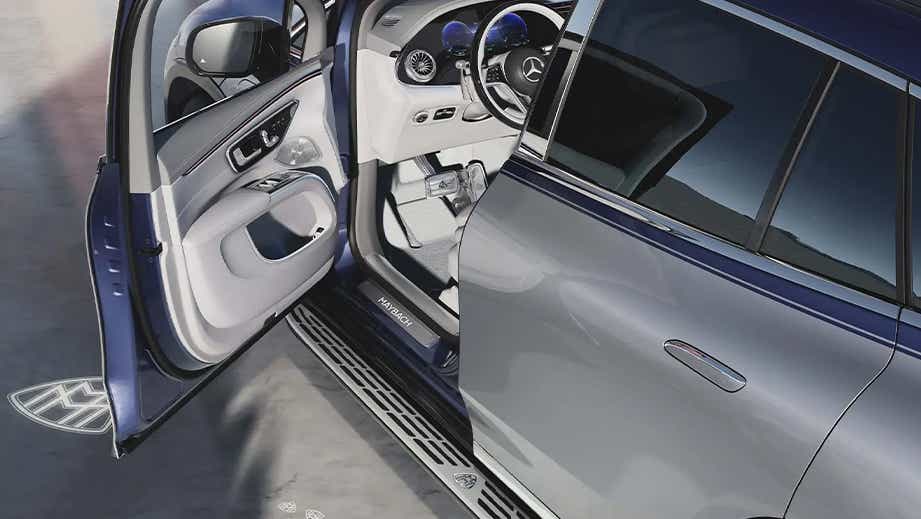 Front door and partial interior view of a Opalite White Mercedes-Benz Maybach EQS