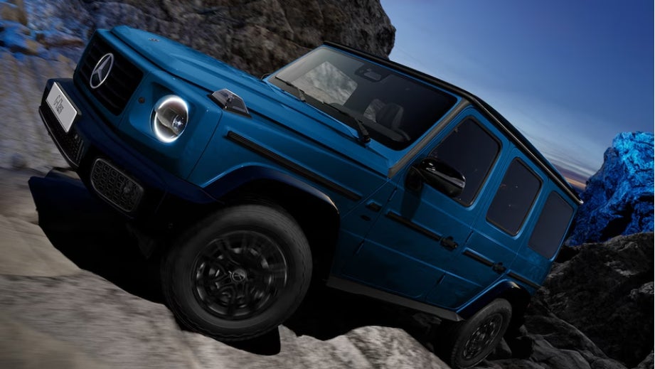 Front three-quarter view of a Mercedes-Benz G-Class Electric climbing rocks