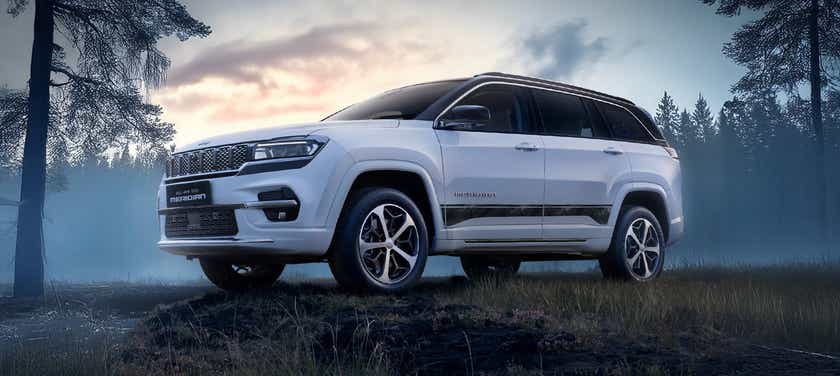 front-side view of a Pearl White Jeep Meridian