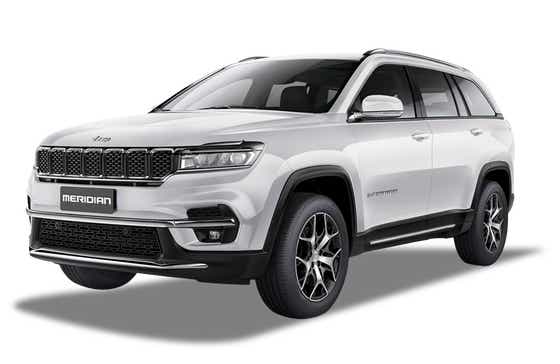 front three-quarter view of a Pearl White Jeep Meridian