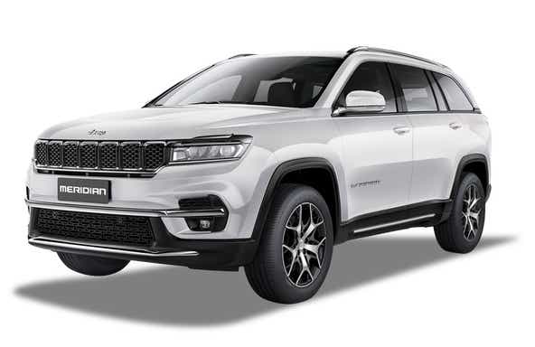 front three-quarter view of a Pearl White Jeep Meridian