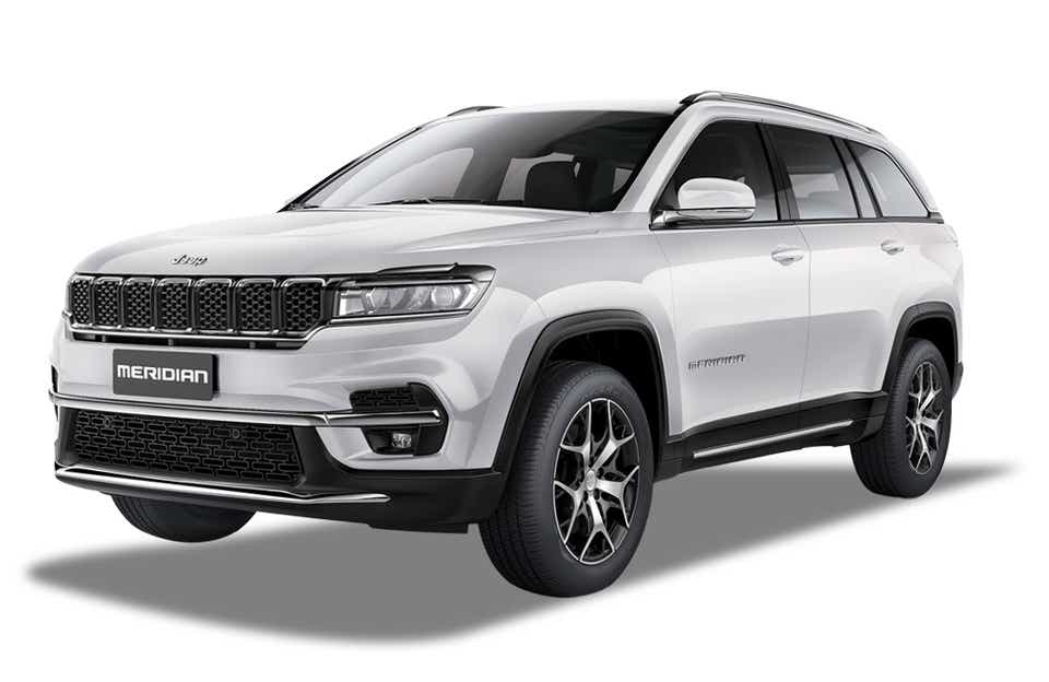 front three-quarter view of a Pearl White Jeep Meridian