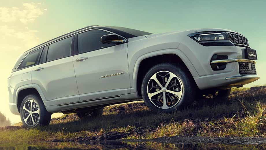 side view of a Pearl White Jeep Meridian