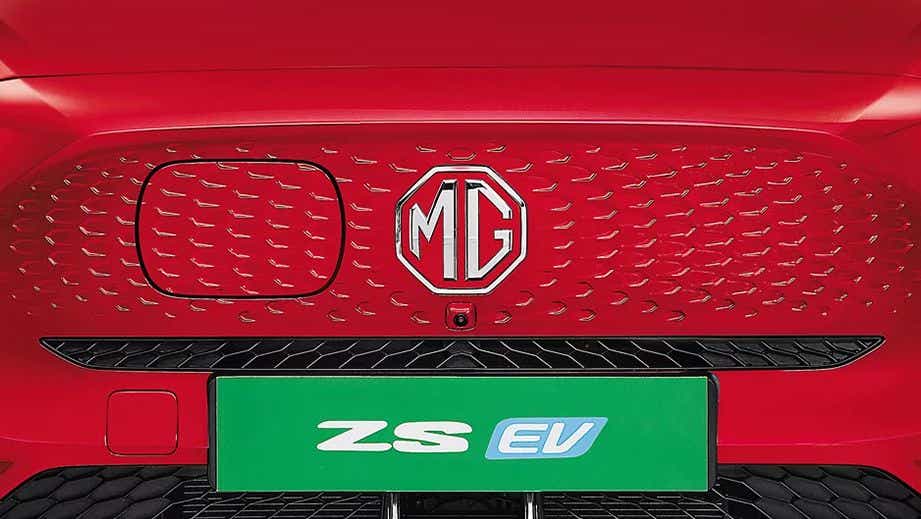 front grille close-up of a Glaze Red MG ZS EV
