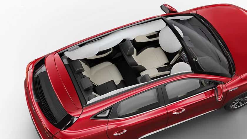top interior view of a Glaze Red MG ZS EV with airbags deployed