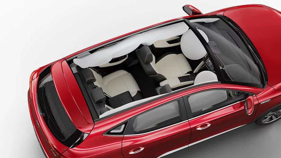 top interior view of a Glaze Red MG ZS EV with airbags deployed