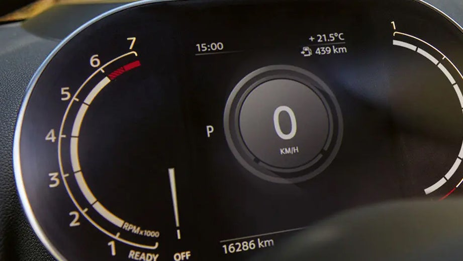 Instrument cluster of a Mini Cooper Countryman displaying speedometer and tachometer