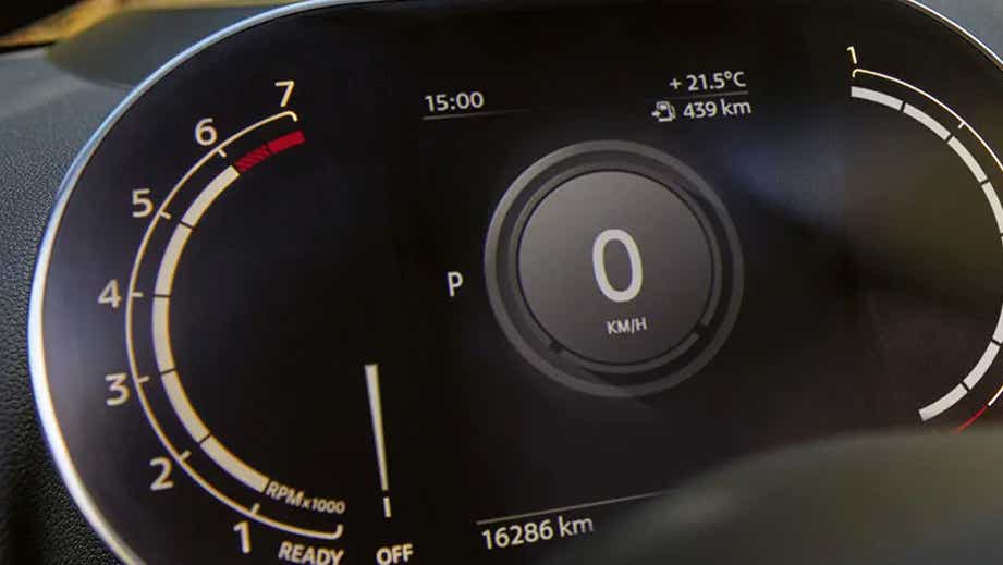 Instrument cluster of a Mini Cooper Countryman displaying speedometer and tachometer