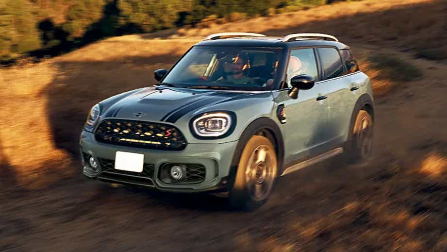 front three-quarter view of a Mini Cooper Countryman driving on a dirt road
