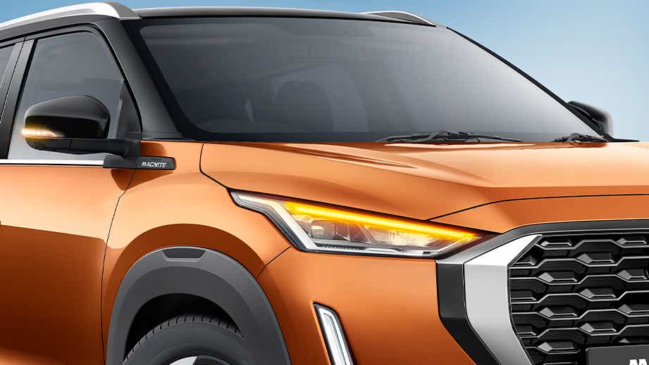 front three-quarter view of a Sunrise Copper Orange Nissan Magnite