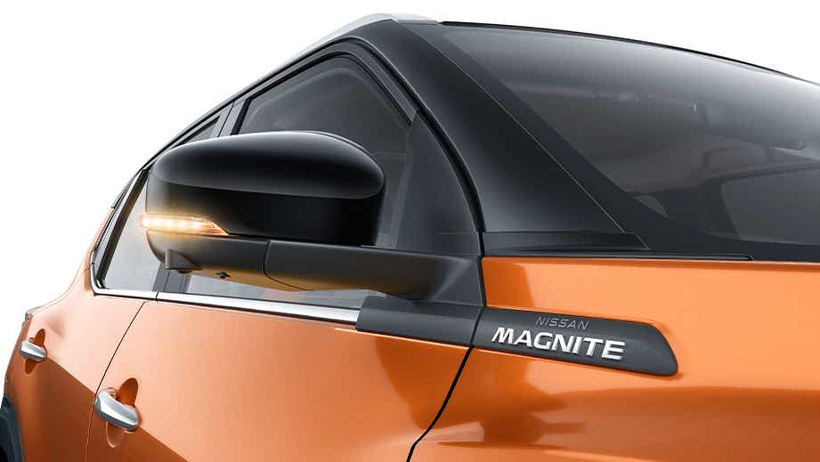 Side mirror and front door badge of a Sunrise Copper Orange Nissan Magnite