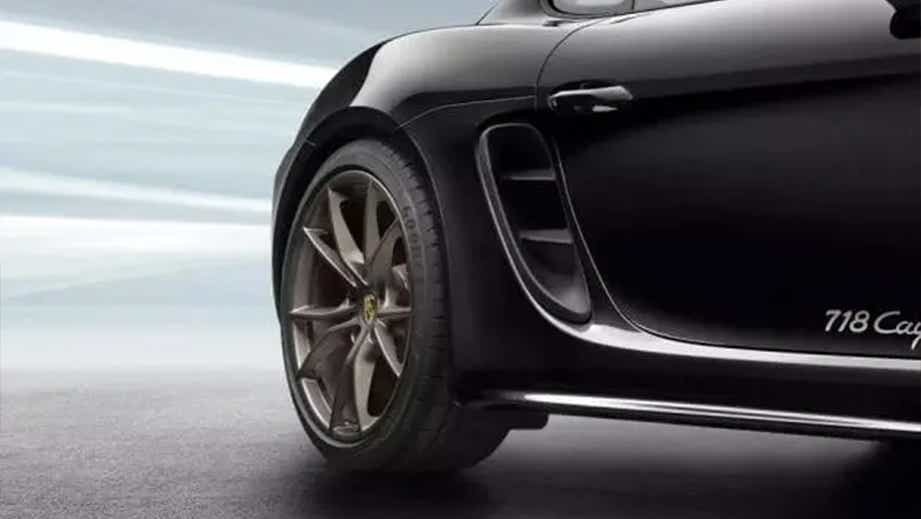 rear wheel and side view of a Jet Black Metallic Porsche 718