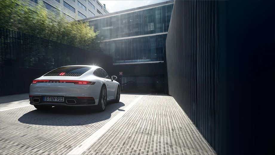 Rear view of a Porsche 911 driving up a ramp