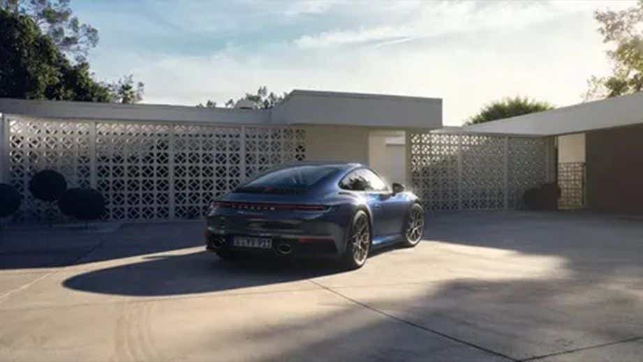 rear view of a Porsche 911 parked in a driveway