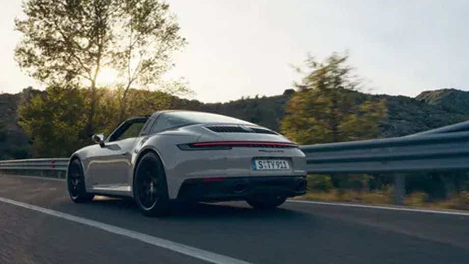 rear three-quarter of a Porsche 911 on a road