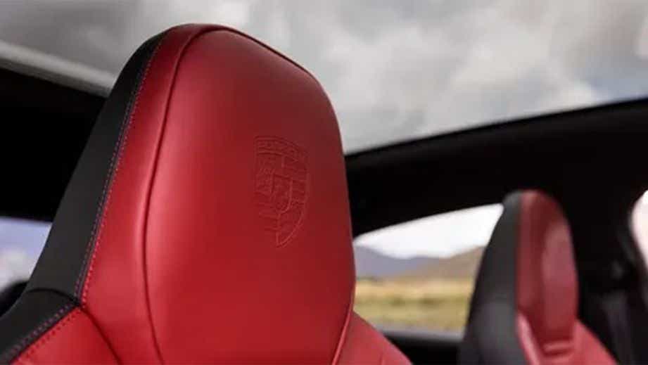 Close-up of the front seat of a Carmine Red Porsche Cayenne Coupe