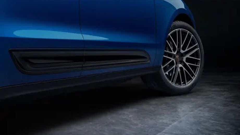 Side view of a Porsche Macan highlighting the rear wheel and lower door panel