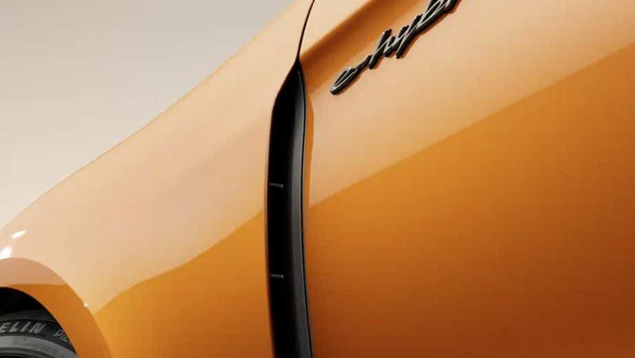 Front quarter panel close-up of a Madeira Gold Metallic Porsche Panamera