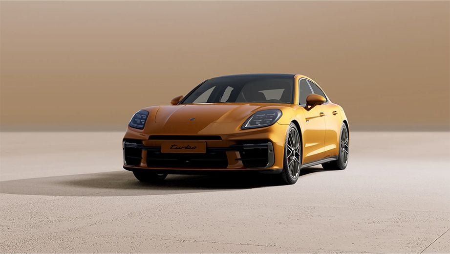 Front three-quarter view of a Madeira Gold Metallic Porsche Panamera