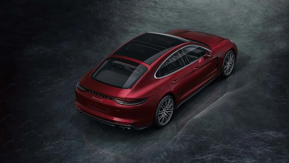 rear three-quarter of a Cherry Metallic Porsche Panamera 2021-2023