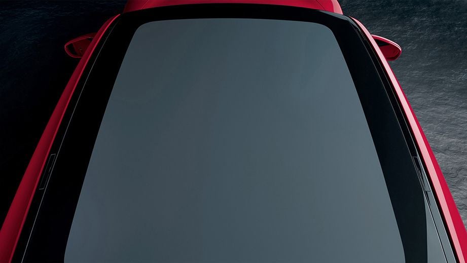 panoramic roof view of a Carmine Red Porsche Taycan