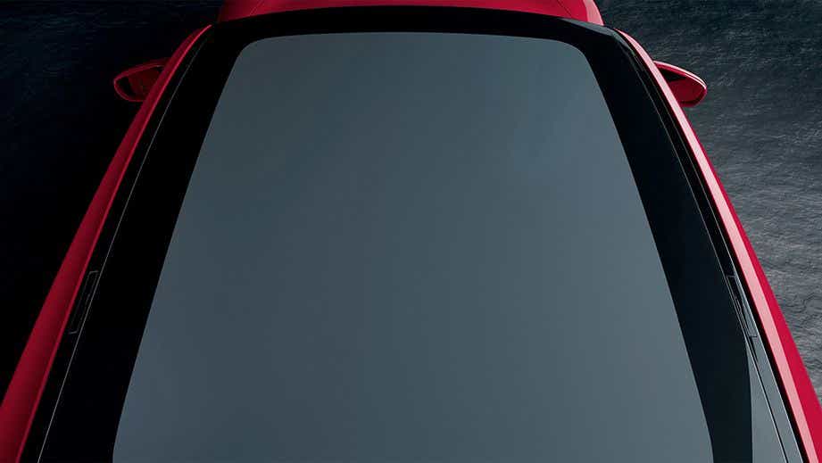 panoramic roof view of a Carmine Red Porsche Taycan