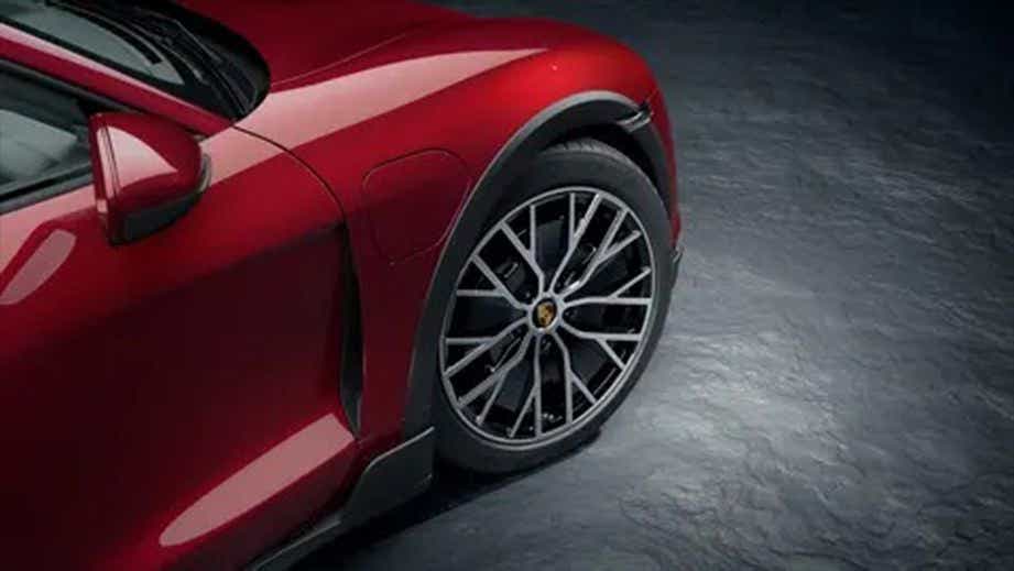 front wheel and fender of a Carmine Red Porsche Taycan
