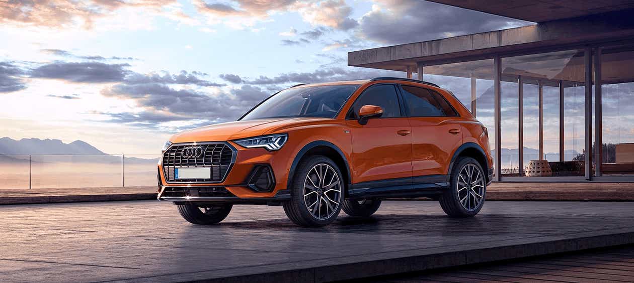 front three-quarter view of a Pulse Orange Solid Audi Q3