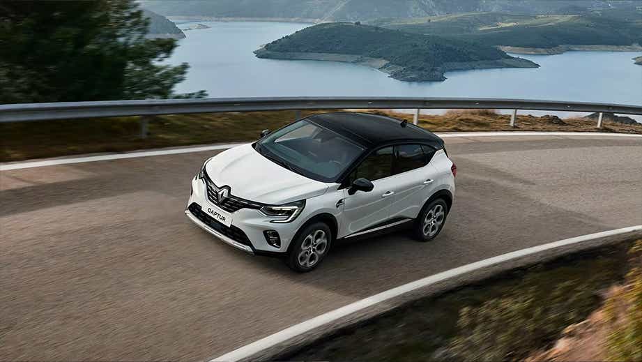 front three-quarter view of a Renault Captur on a winding road