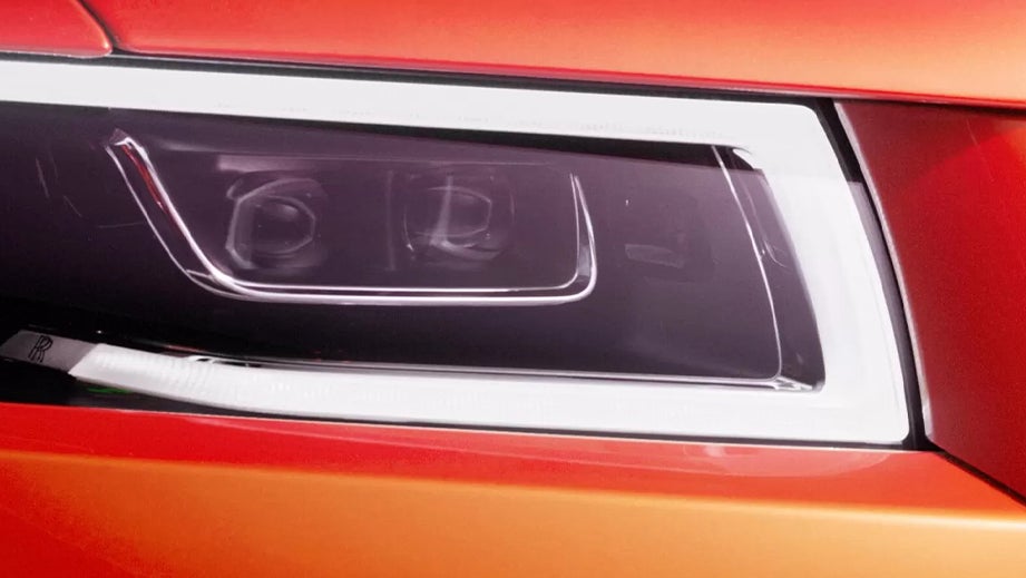 Headlight close-up of a Rolls-Royce Ghost