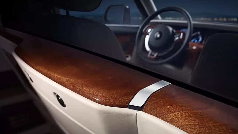 Interior detail of a Rolls-Royce Phantom showcasing the dashboard and steering wheel