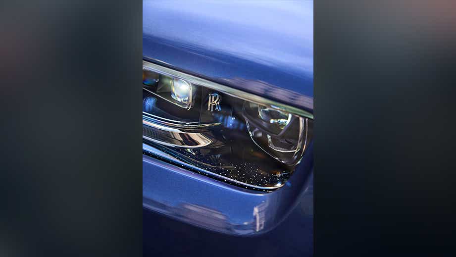 Headlight close-up of a Rolls-Royce Phantom
