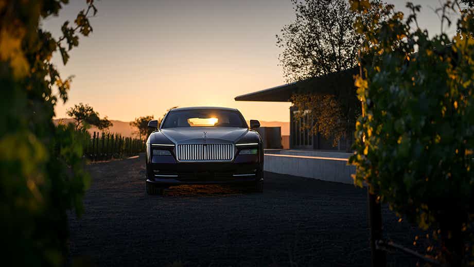 Front view of a Rolls-Royce Spectre at sunset