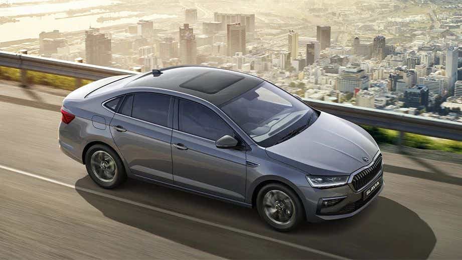 side view of a Skoda Slavia sedan driving on a road