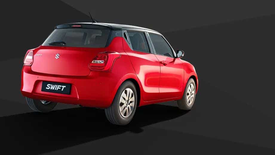 rear three-quarter of a Solid Fire Red with Pearl midnight black roof Maruti Suzuki Swift 2021 - 2023