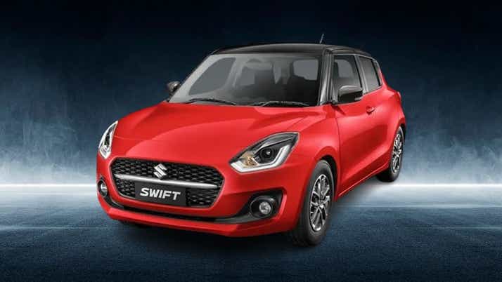 front three-quarter view of a Solid Fire Red with Pearl midnight black roof Maruti Suzuki Swift 2021 - 2023