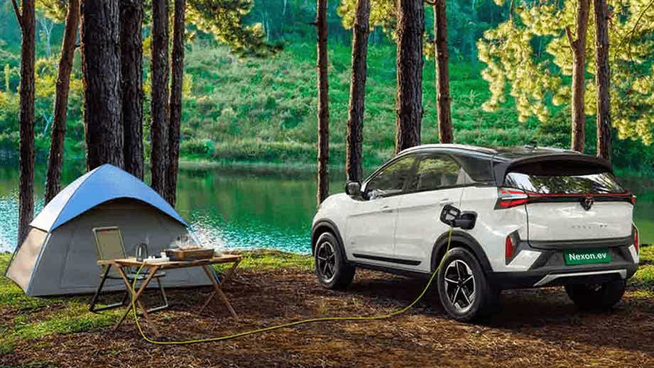rear three-quarter of a Tata Nexon EV charging near a lake