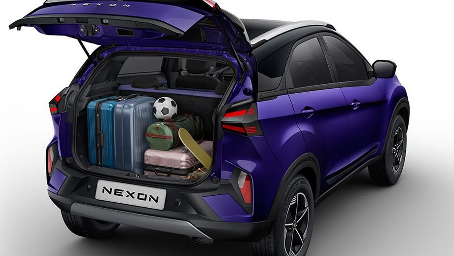 Rear view with boot open of a Royal Blue Tata Nexon loaded with luggage