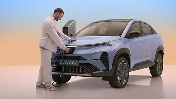 Front three-quarter view of a Tata Curvv EV being charged