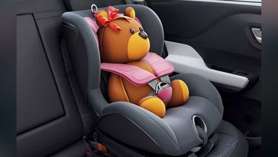 Rear seat interior featuring a Tata Punch car seat with a teddy bear strapped in