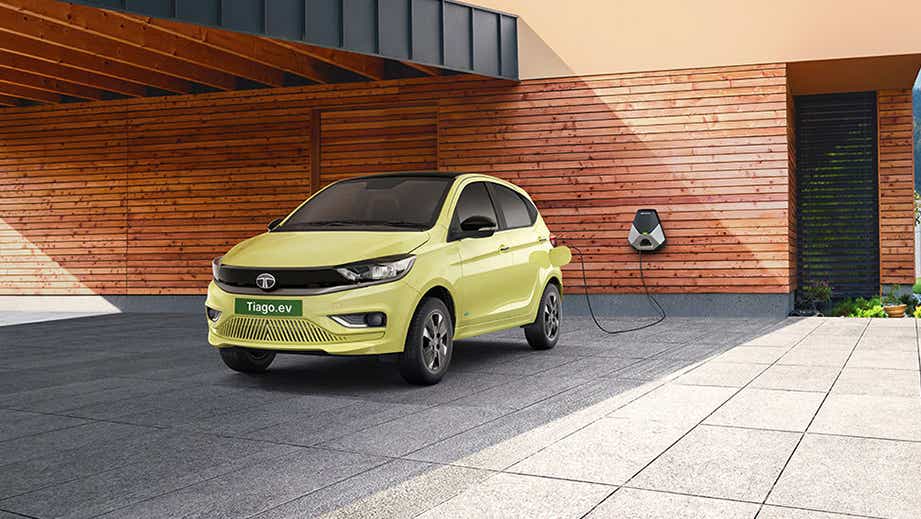 Front three-quarter view of a Chill Lime With Dual Tone Tata Tiago EV charging
