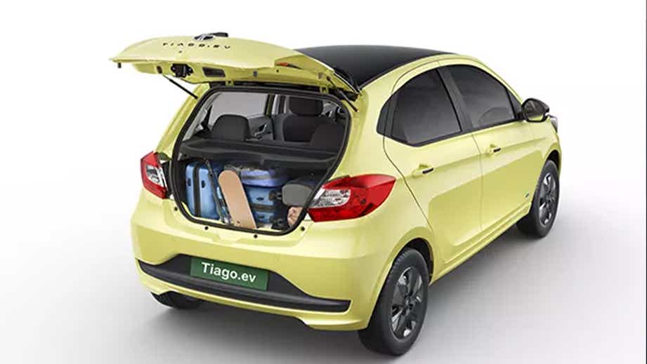 Rear three-quarter view of a Chill Lime With Dual Tone Tata Tiago EV with open boot