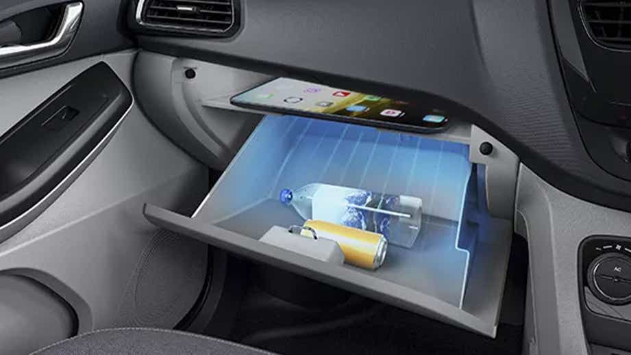 Glovebox view of a Tata Tiago. Interior compartment with storage area open.