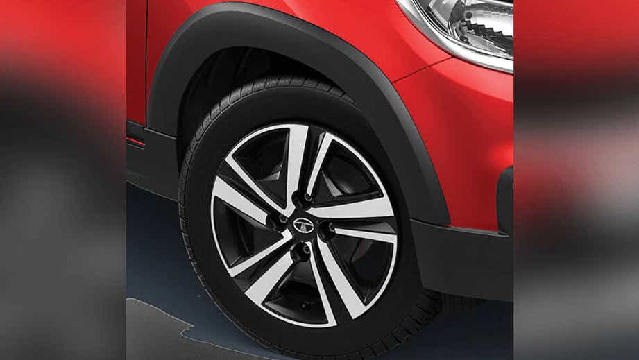 Front wheel and fender close-up of a Fire Red Tata Tiago NRG